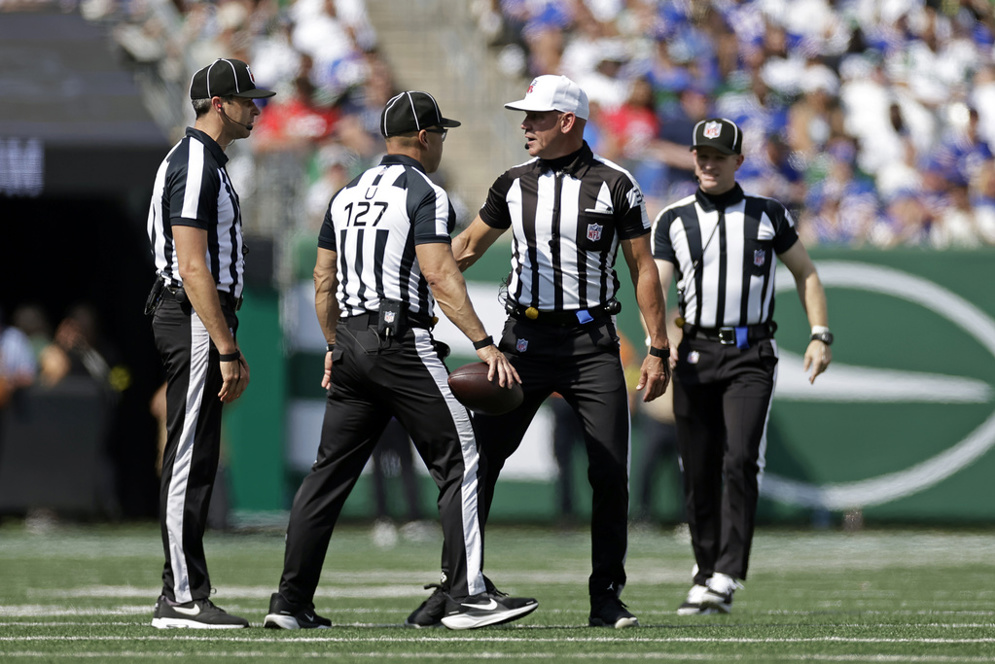 Officials gather during an NFL game. (AP/Adam Hunger)